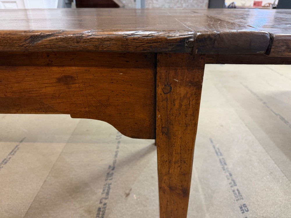 A long antique oak extending dining table featuring two end extension leaves, side frieze drawers, and tapered square legs. View IV