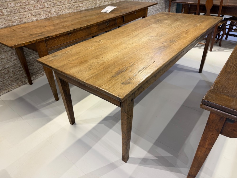 A 19th-century rectangular solid oak farmhouse dining table with four tapered square legs and visible wood grain on the top surface. View II