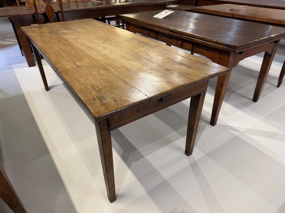 A 19th-century rectangular solid oak farmhouse dining table with four tapered square legs and visible wood grain on the top surface. View IV