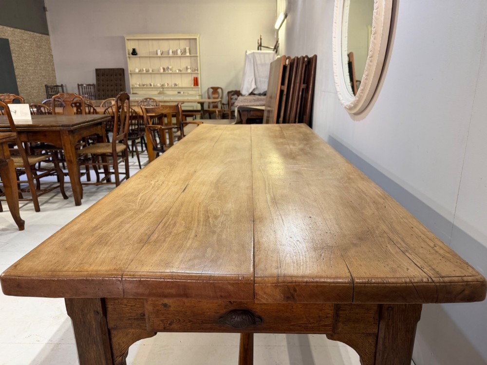 A 19th-century French beech farmhouse dining table with a light timber plank top and dark wooden frame supported by an H-stretcher. View III