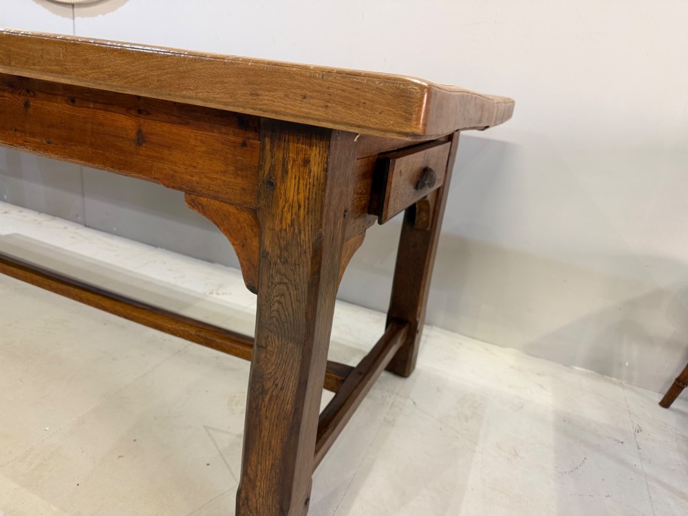 A 19th-century French beech farmhouse dining table with a light timber plank top and dark wooden frame supported by an H-stretcher. View V