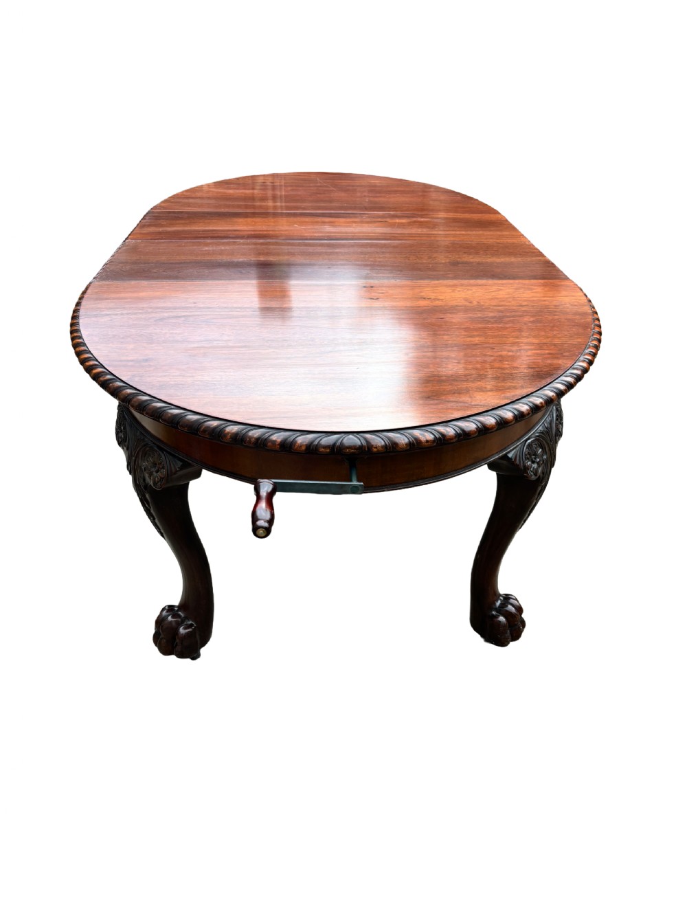 An oval mahogany Chippendale style extending dining table with carved cabriole legs, ball and claw feet, and a rope-twist carved apron rim. View II