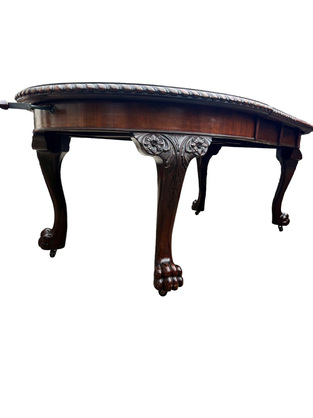 An oval mahogany Chippendale style extending dining table with carved cabriole legs, ball and claw feet, and a rope-twist carved apron rim. View IV