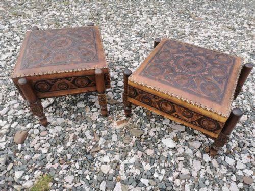 A LARGE PAIR OF ANTIQUE EASTERN EMBOSSED AND DECORATED LEATHER AND WALNUT FRAMED STOOLS - ADDITIONAL PHOTO 1