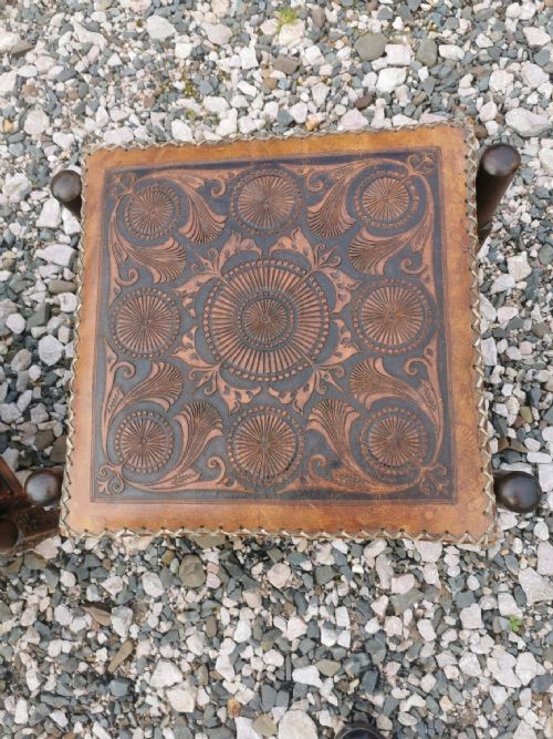 A LARGE PAIR OF ANTIQUE EASTERN EMBOSSED AND DECORATED LEATHER AND WALNUT FRAMED STOOLS - ADDITIONAL PHOTO 3