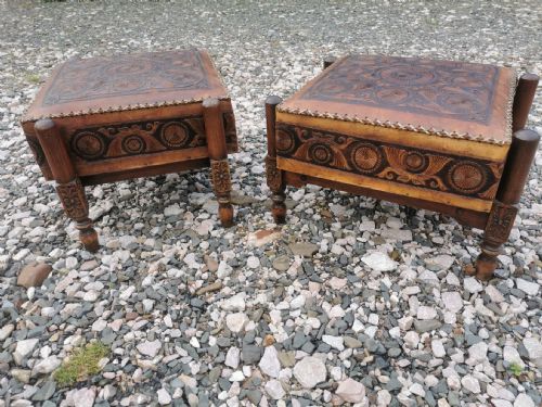 A LARGE PAIR OF ANTIQUE EASTERN EMBOSSED AND DECORATED LEATHER AND WALNUT FRAMED STOOLS - ADDITIONAL PHOTO 4