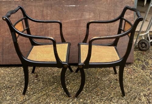 AN ANTIQUE PAIR OF EBONISED AND CANE ELBOW CHAIRSIN THE REGENCY STYLE - ADDITIONAL PHOTO 2