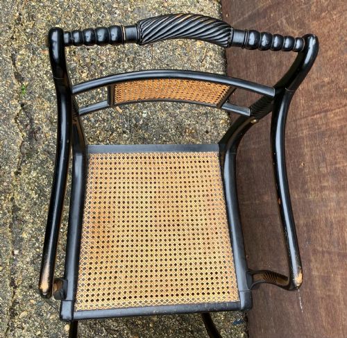 AN ANTIQUE PAIR OF EBONISED AND CANE ELBOW CHAIRSIN THE REGENCY STYLE - ADDITIONAL PHOTO 3
