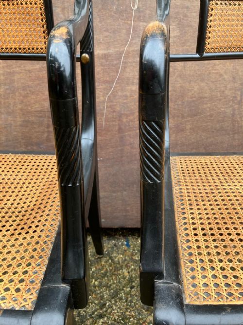 AN ANTIQUE PAIR OF EBONISED AND CANE ELBOW CHAIRSIN THE REGENCY STYLE - ADDITIONAL PHOTO 4