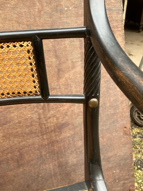 AN ANTIQUE PAIR OF EBONISED AND CANE ELBOW CHAIRSIN THE REGENCY STYLE - ADDITIONAL PHOTO 5