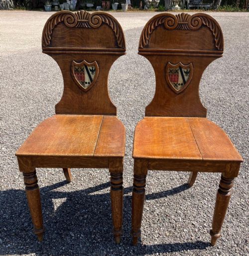 a pair of regency hall chairs in oak with heraldic painted crests - CATEGORY: ANTIQUE CHAIRS - DATED REGENCY
