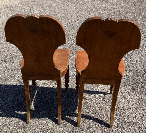 A PAIR OF REGENCY HALL CHAIRS IN OAK WITH HERALDIC PAINTED CRESTS - ADDITIONAL PHOTO 2