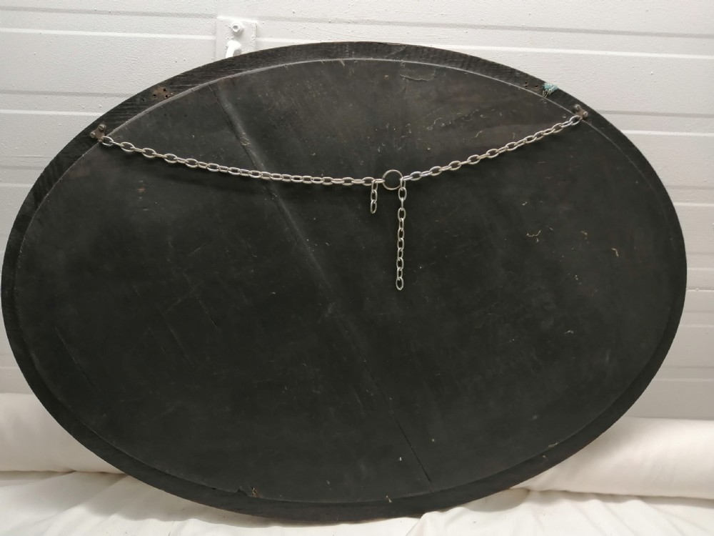 A large Edwardian oval oak mirror. View VI