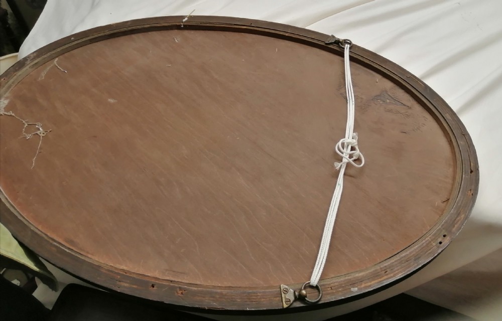 Antique oak oval mirror with beveled edges. View II