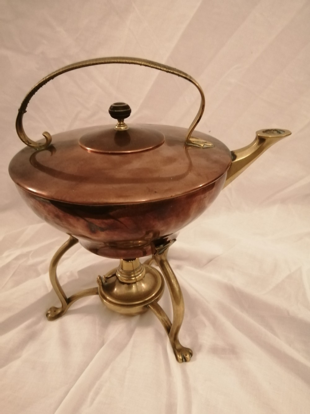 An arts and crafts W.A.S Benson brass and copper kettle on stand.