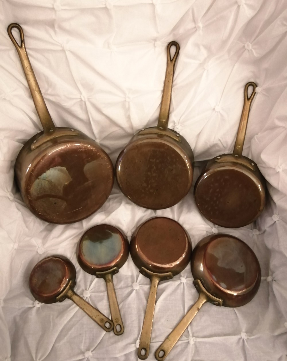 Set of French copper and brass pans.