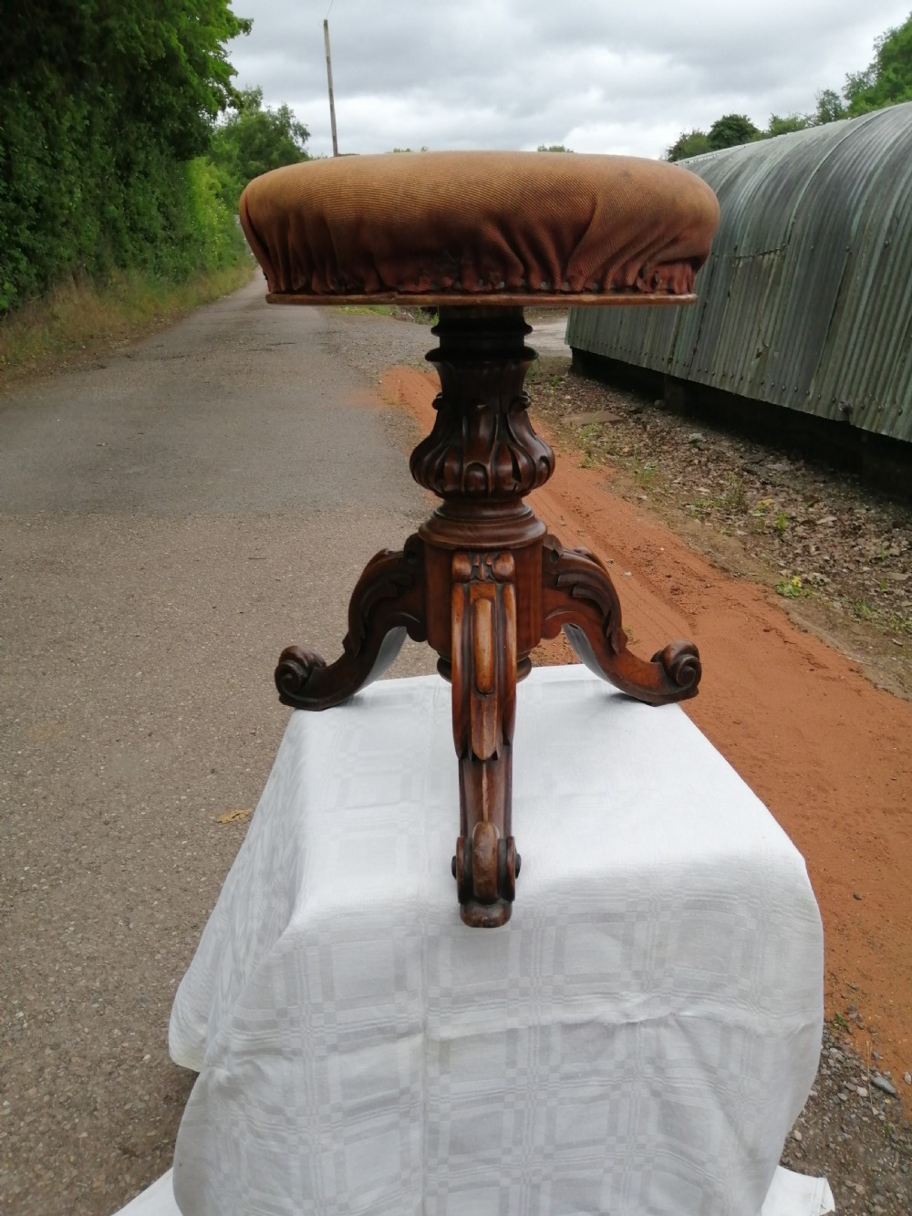 A Victorian carved walnut revolving piano stool.
