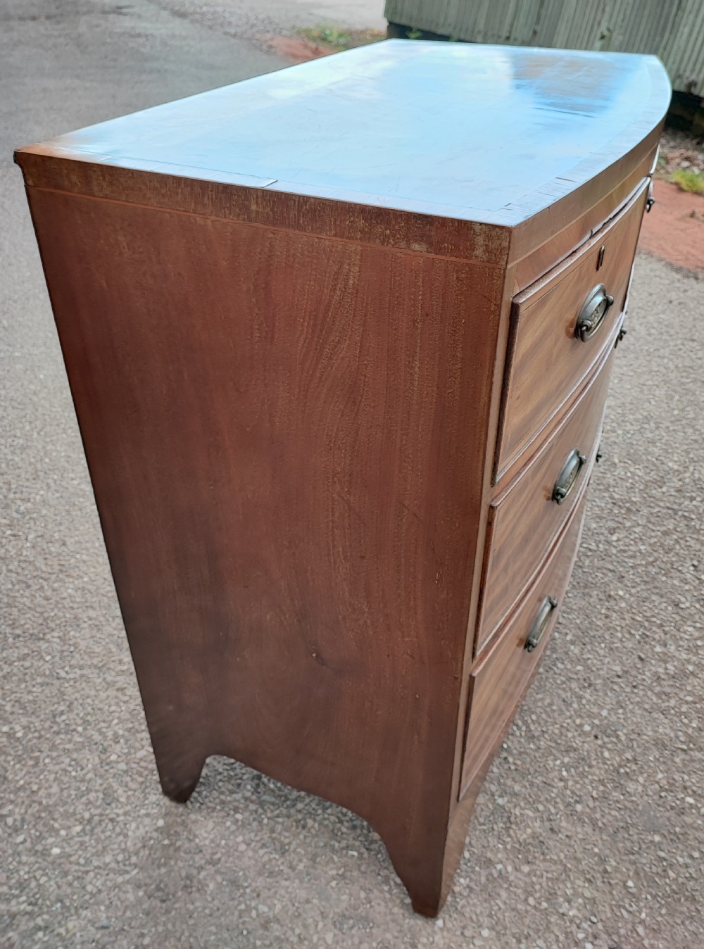 An antique regency inlaid bow front chest  View II