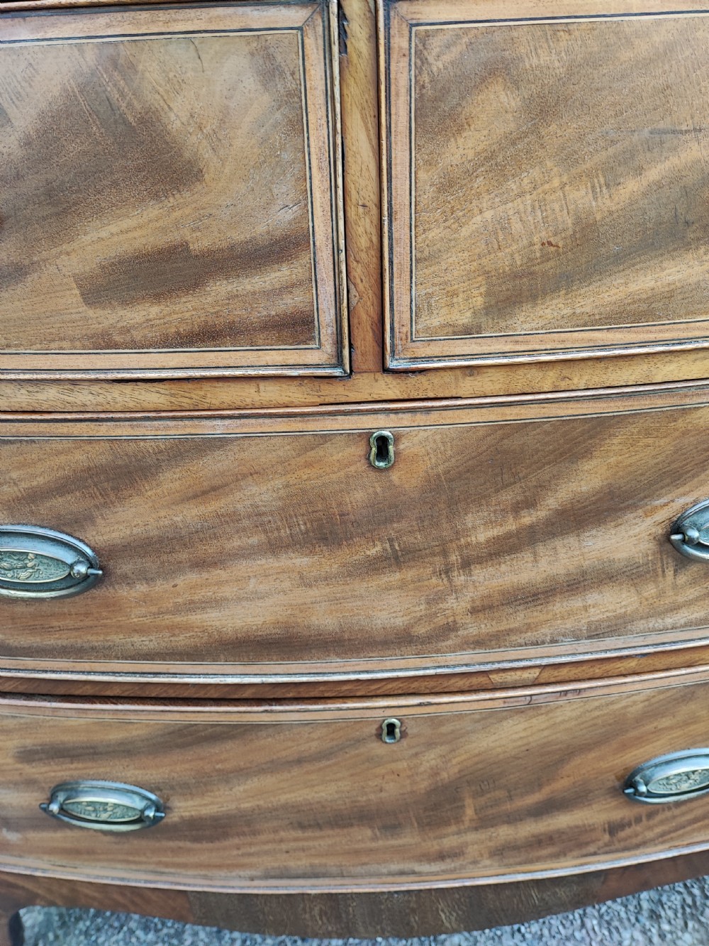 An antique regency inlaid bow front chest  View III