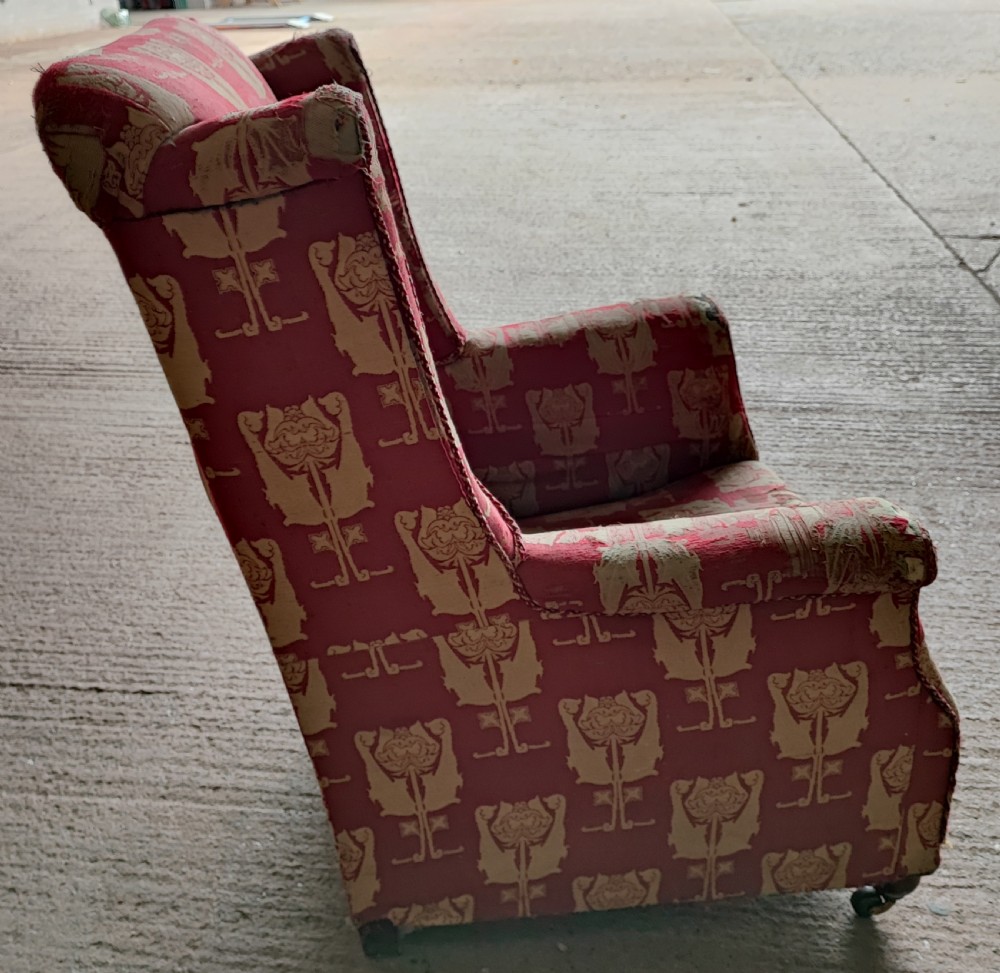 An Arts and Crafts wing arm  chair with original upholstery. View IX