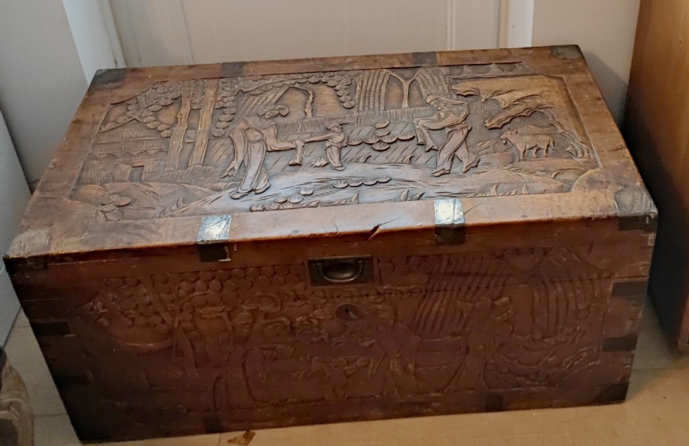 An antique brass bound  chinese  carved camphor trunk 