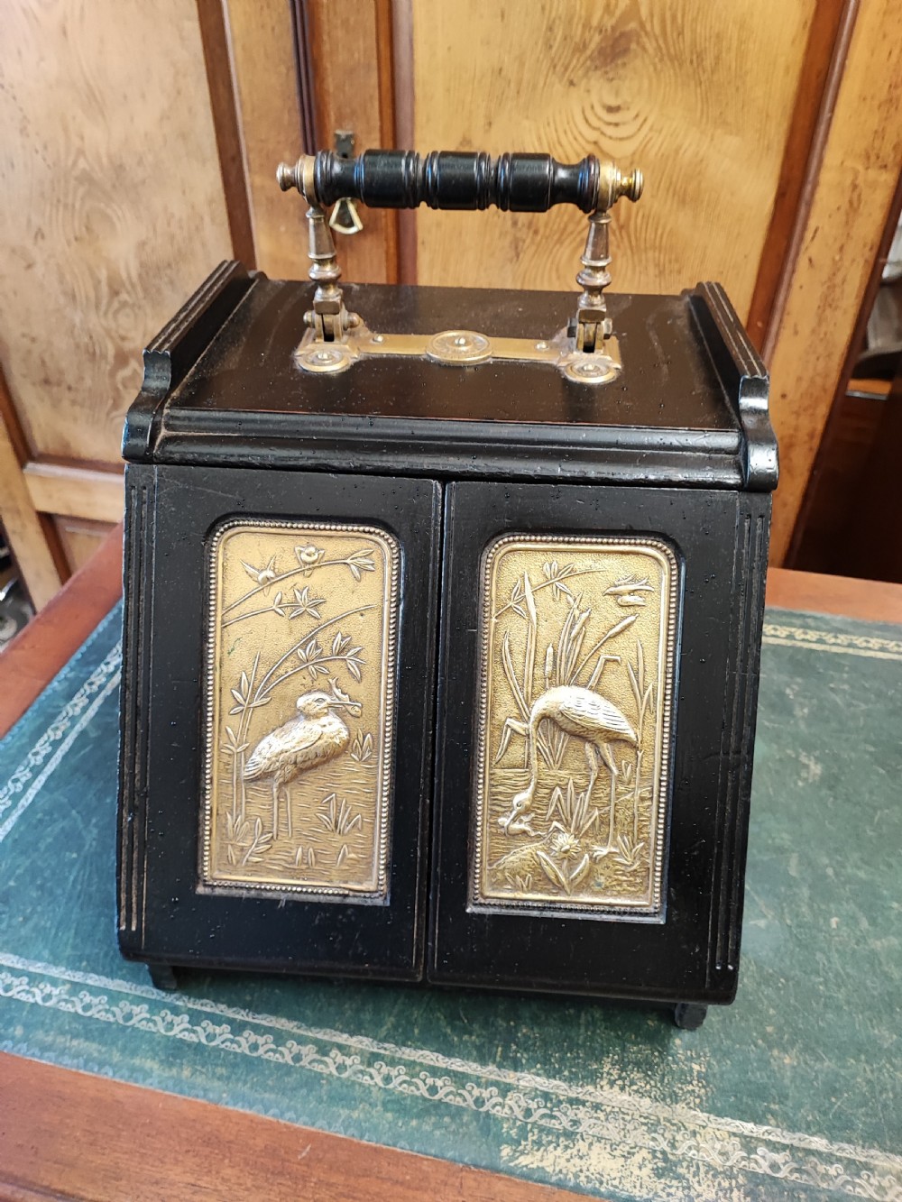 Esthetic movement ebonized and brass panelling ( patent) coalbox.