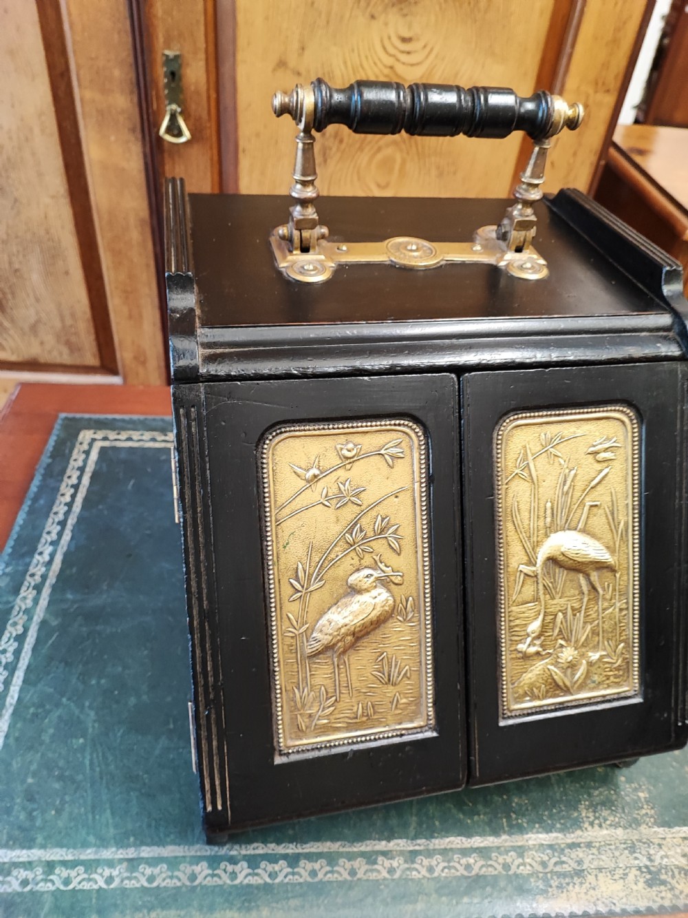 Esthetic movement ebonized and brass panelling ( patent) coalbox. View VIII
