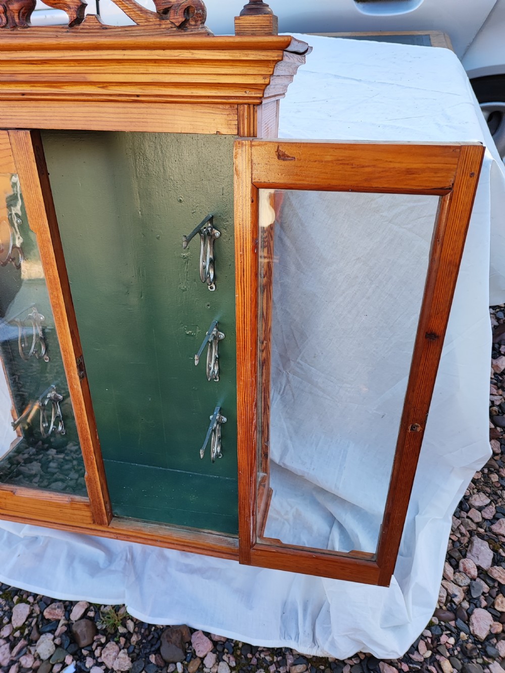 A 19c carved pine wall hanging cabinet. View X