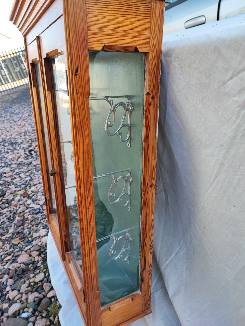 A 19c carved pine wall hanging cabinet. View XII
