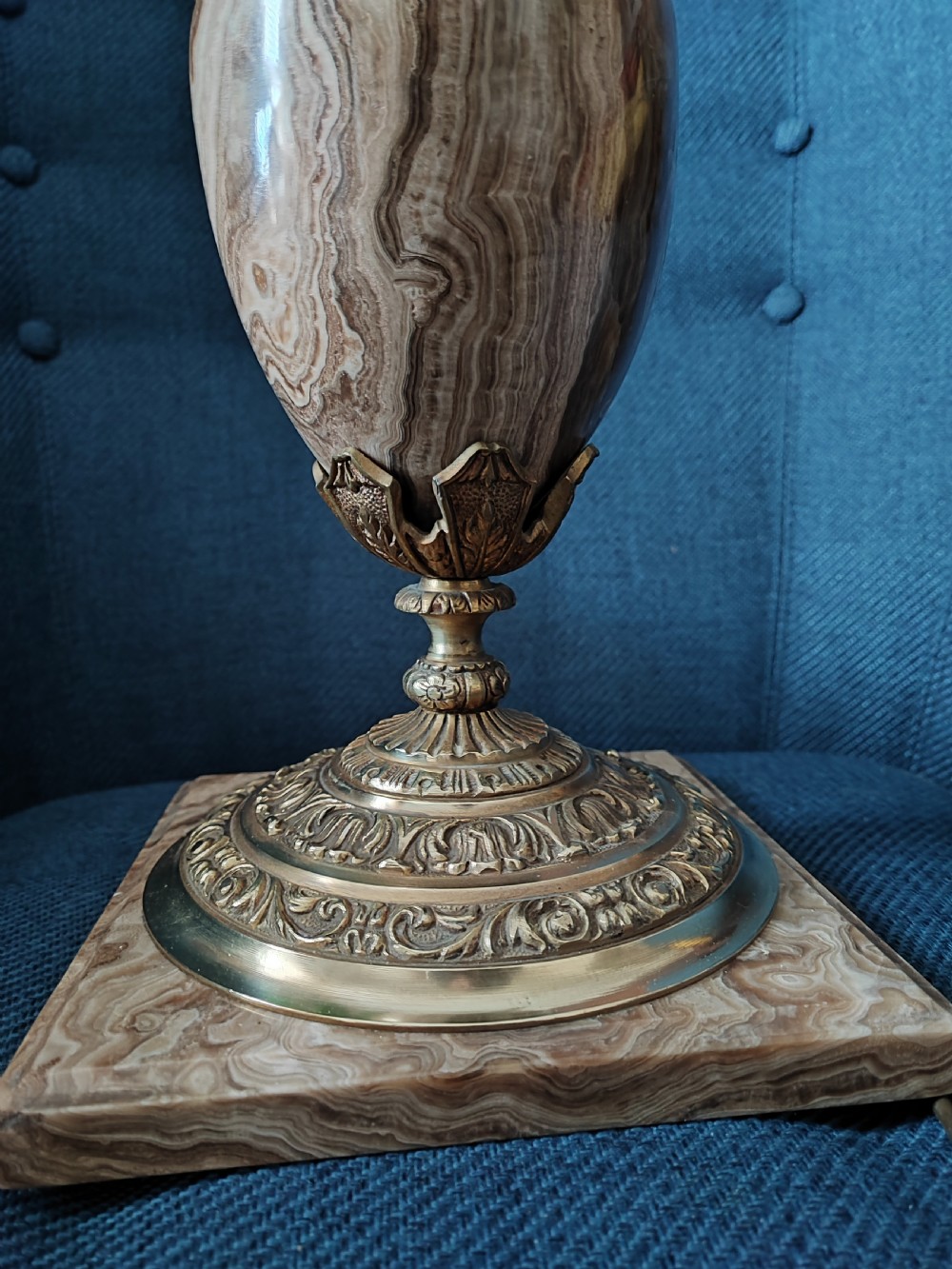 An antique French urn-form table lamp composed of veined brown marble with cast gilt bronze acanthus mounts on a square stone base. View VII