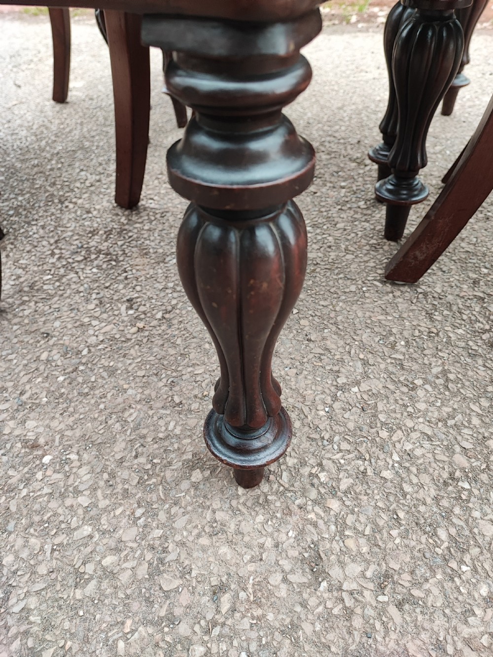 A set of six Victorian balloon back dining chairs made of dark mahogany wood with soft green upholstered seats. View II