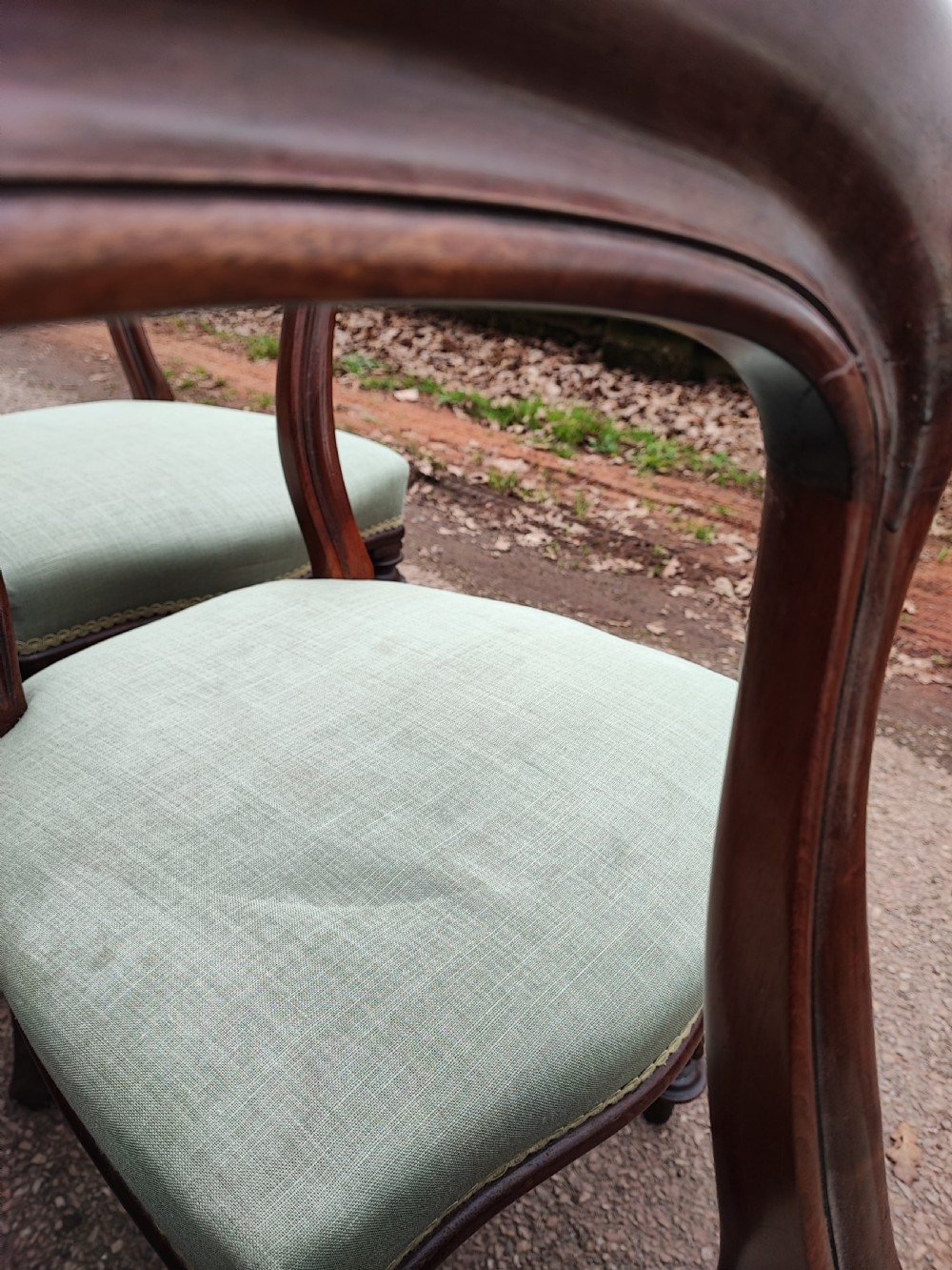 A set of six Victorian balloon back dining chairs made of dark mahogany wood with soft green upholstered seats. View VI