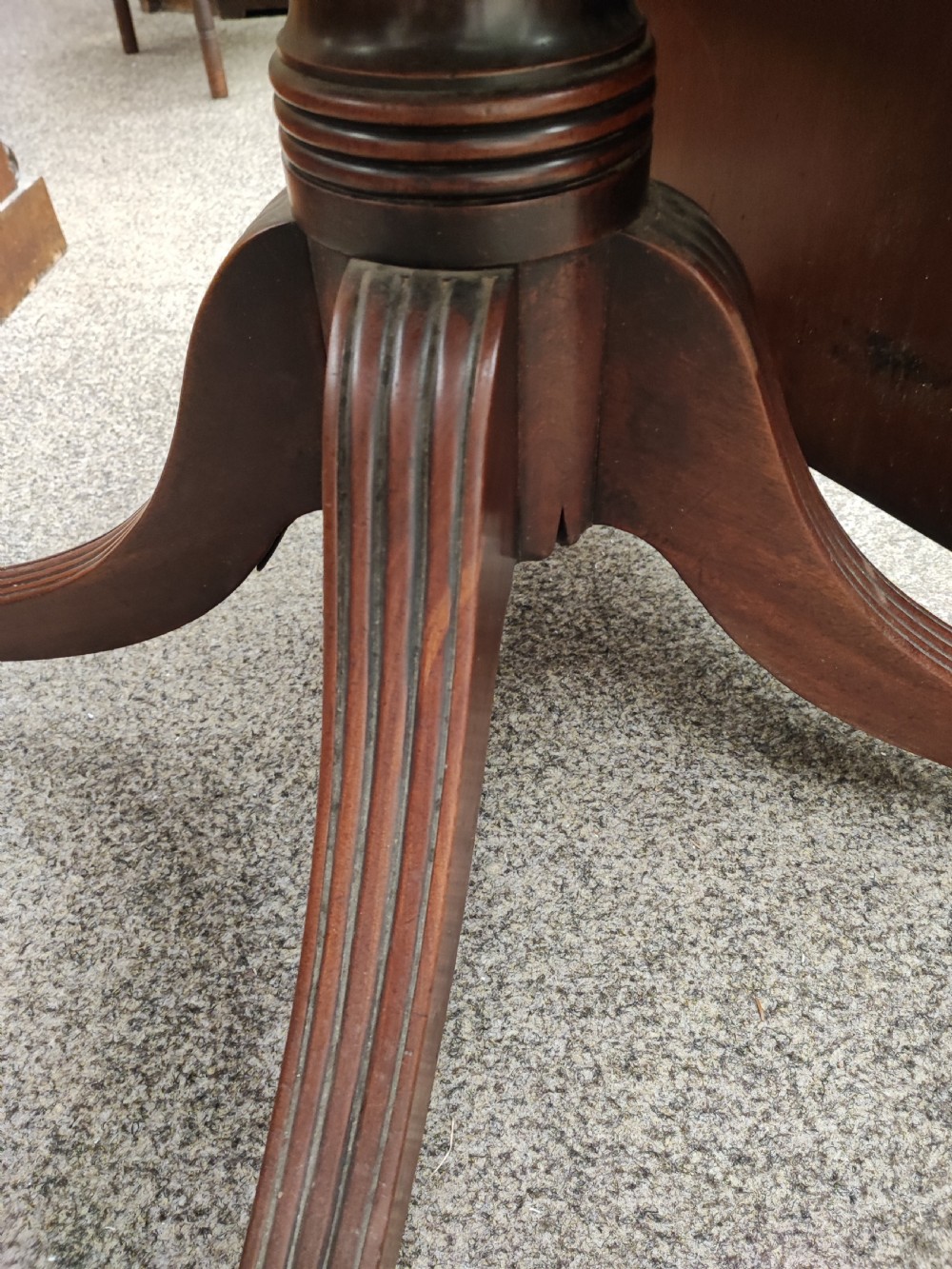 A fine regency cross banded mahogany dining table. View V