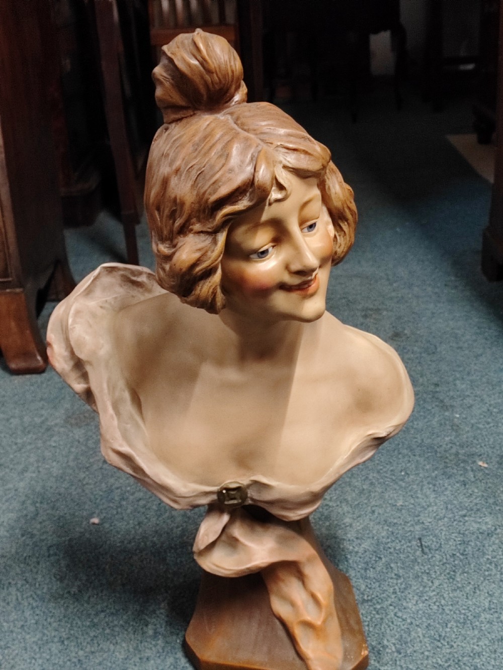 An antique French painted terracotta bust with glass eyes 