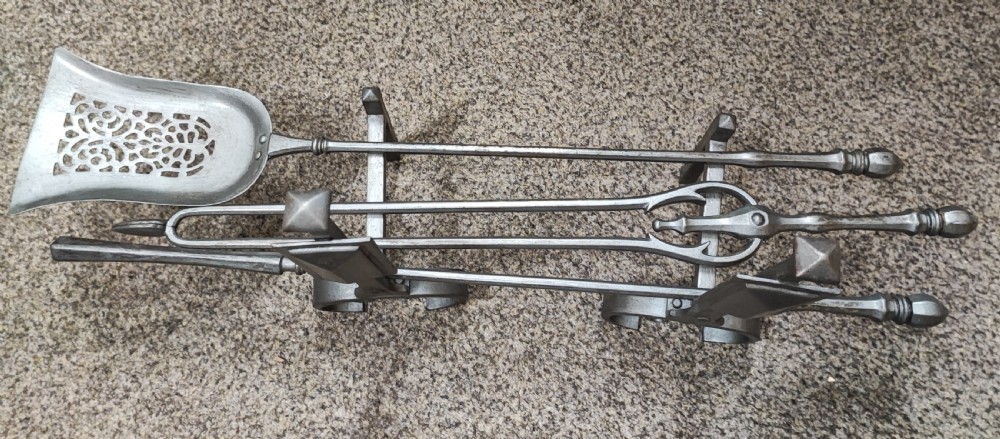 A fine set of art's and crafts polished steel fire irons. Plus fire dogs 