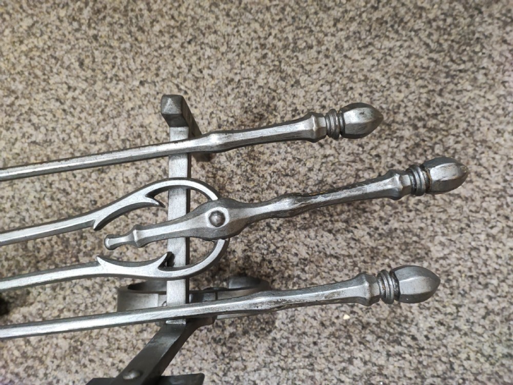 A fine set of art's and crafts polished steel fire irons. Plus fire dogs  View II