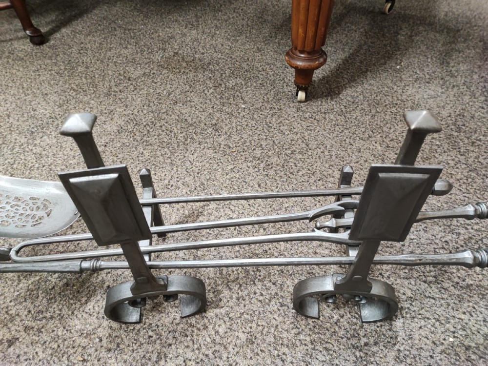 A fine set of art's and crafts polished steel fire irons. Plus fire dogs  View III