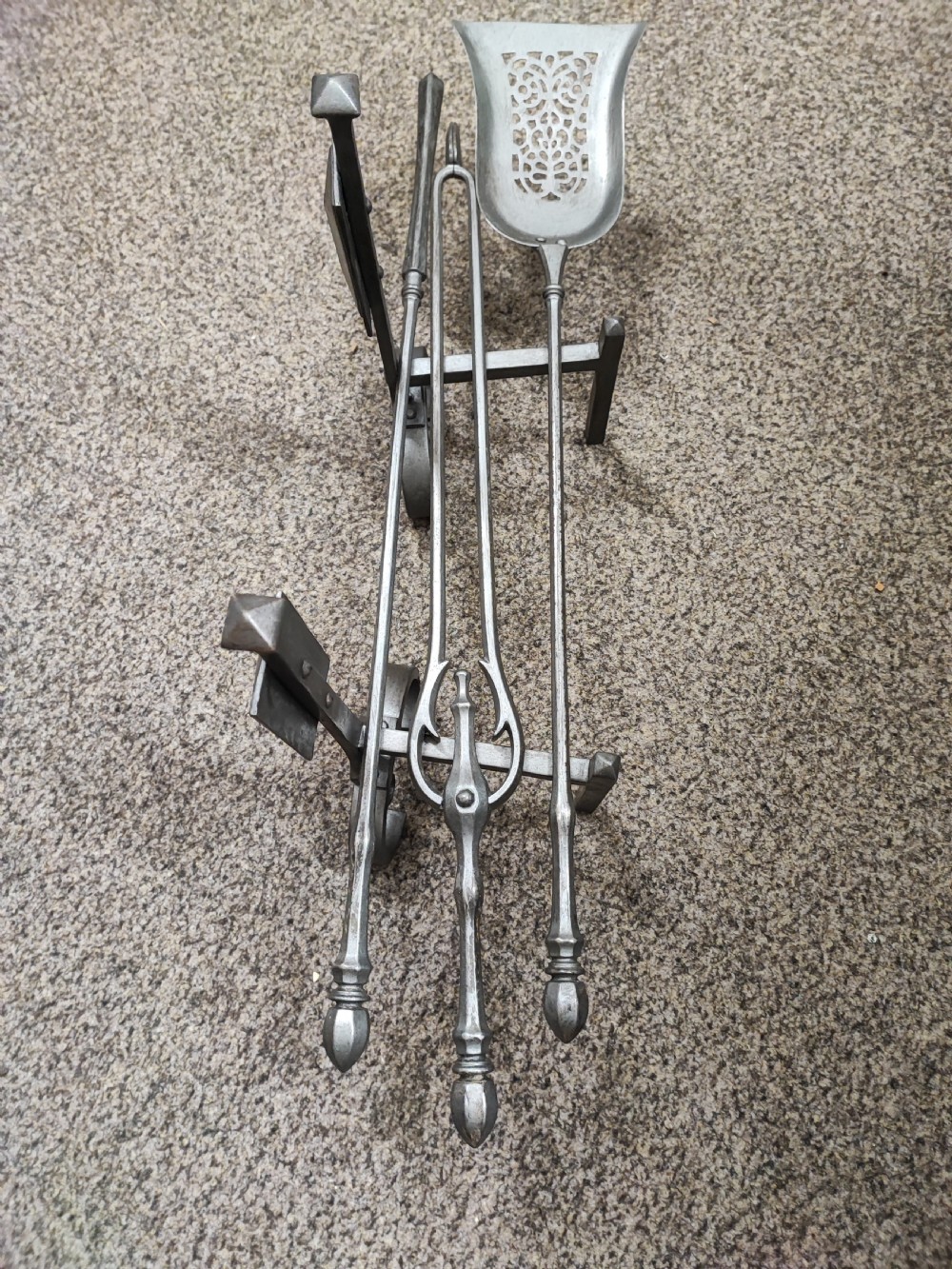 A fine set of art's and crafts polished steel fire irons. Plus fire dogs  View V