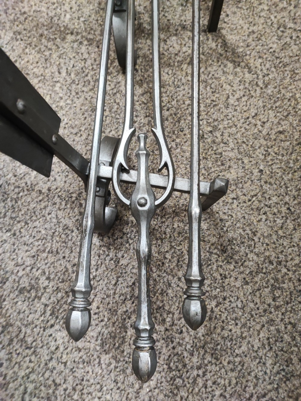 A fine set of art's and crafts polished steel fire irons. Plus fire dogs  View VI