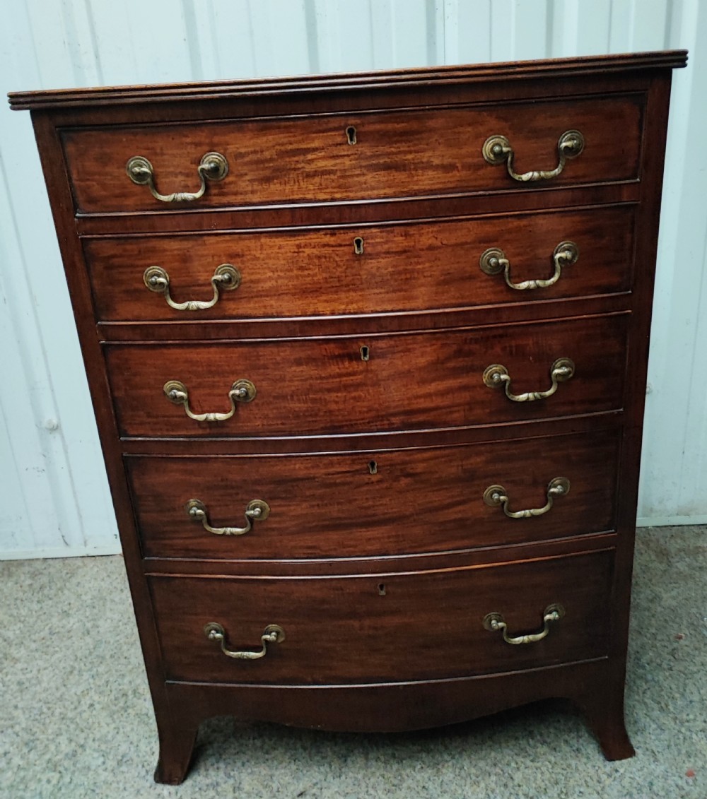 An antique mahogany bow front chest of drawers.