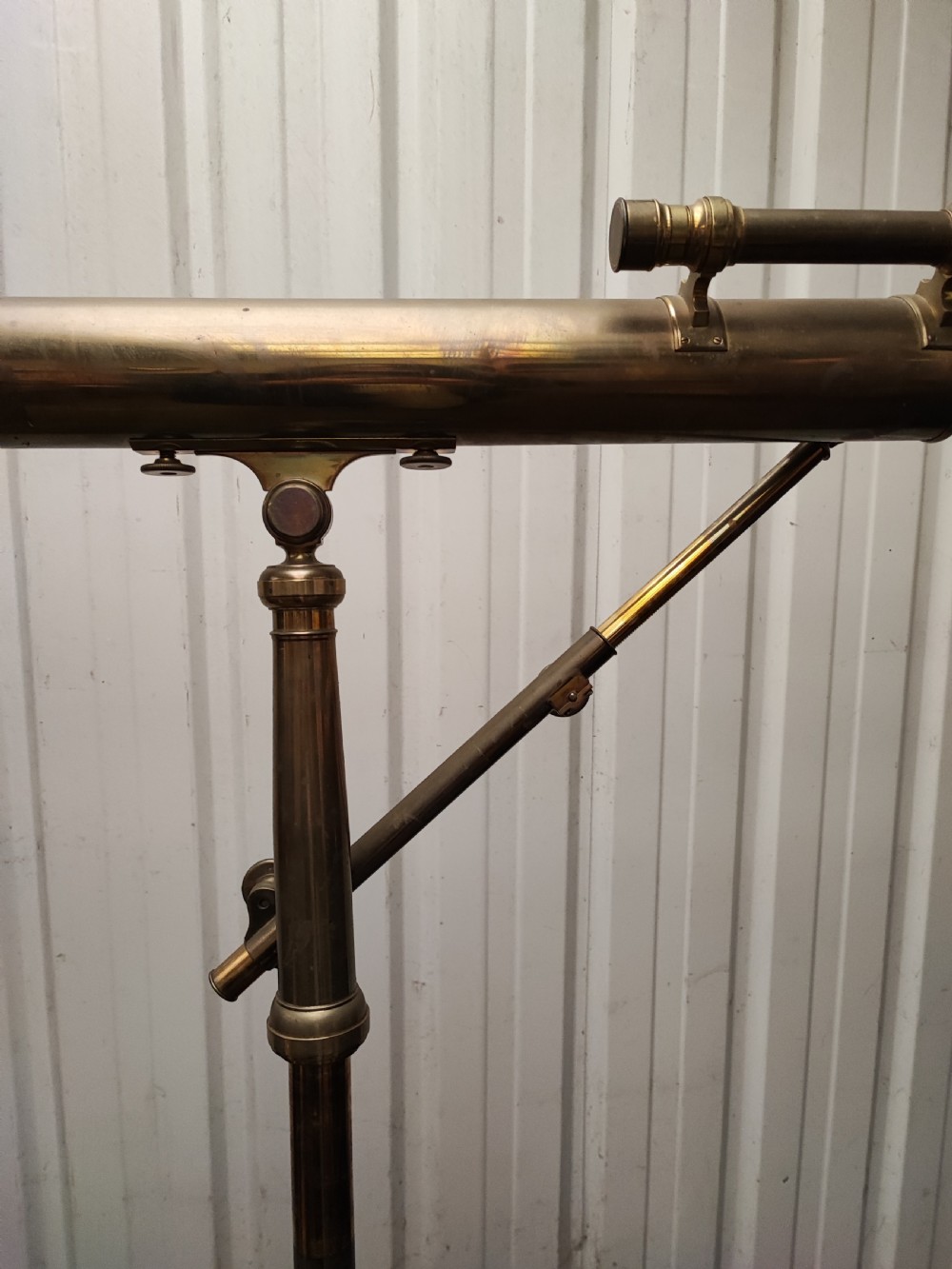 A good and large antique brass telescope on original tripod stand. View IX