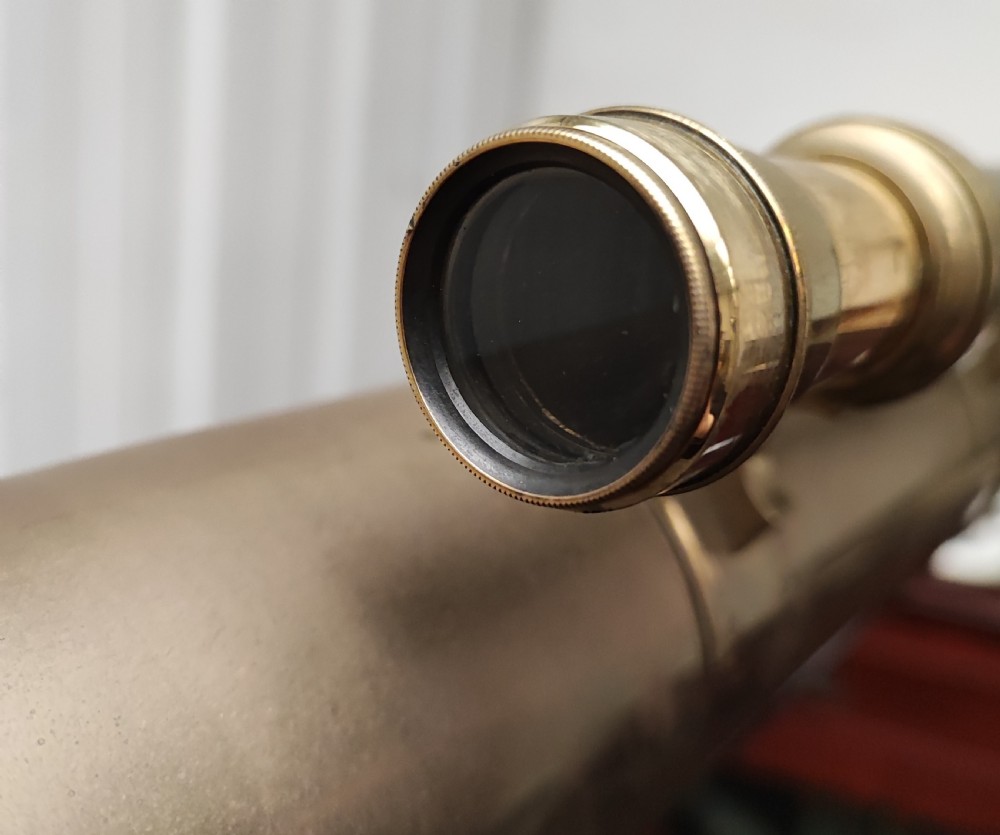 A good and large antique brass telescope on original tripod stand. View XVI
