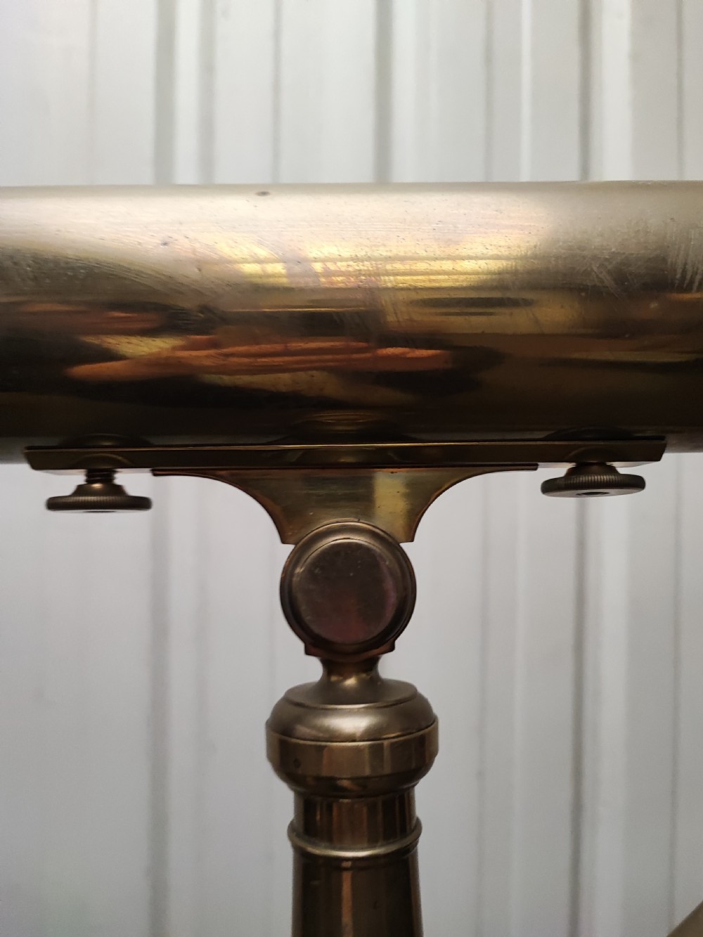 A good and large antique brass telescope on original tripod stand. View XXIV