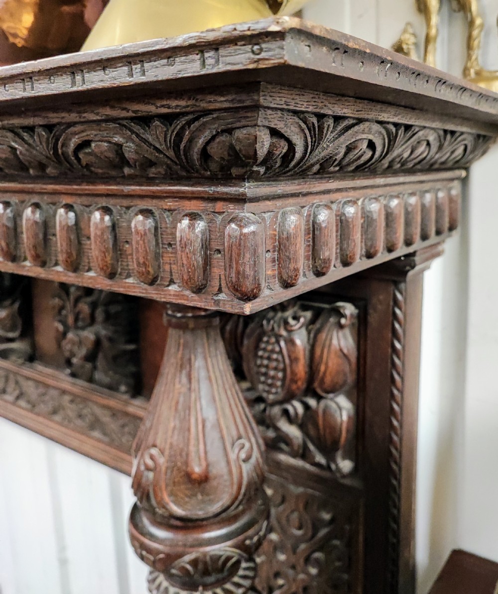 Impressive antique carved oak fire surround. View VI