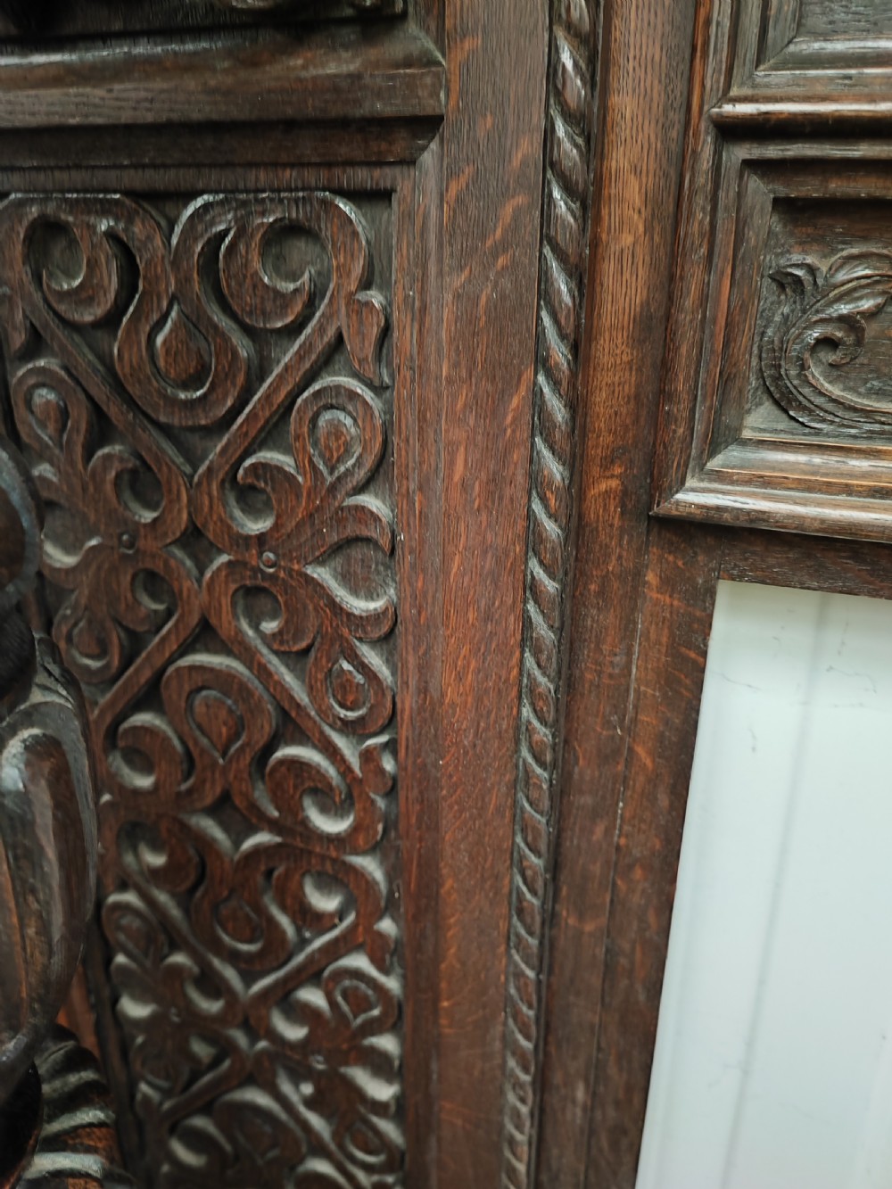 Impressive antique carved oak fire surround. View XIII