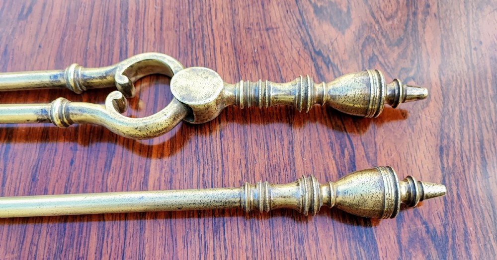 A pretty Georgian set of 3 brass fire irons. View III