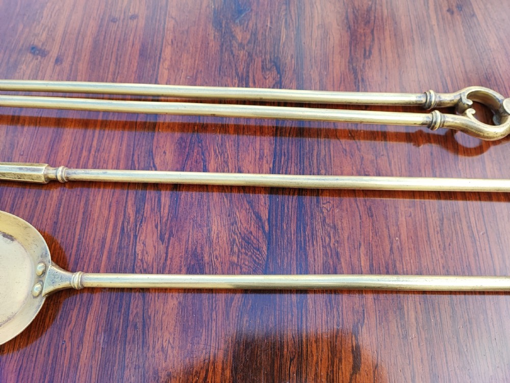 A pretty Georgian set of 3 brass fire irons. View IV
