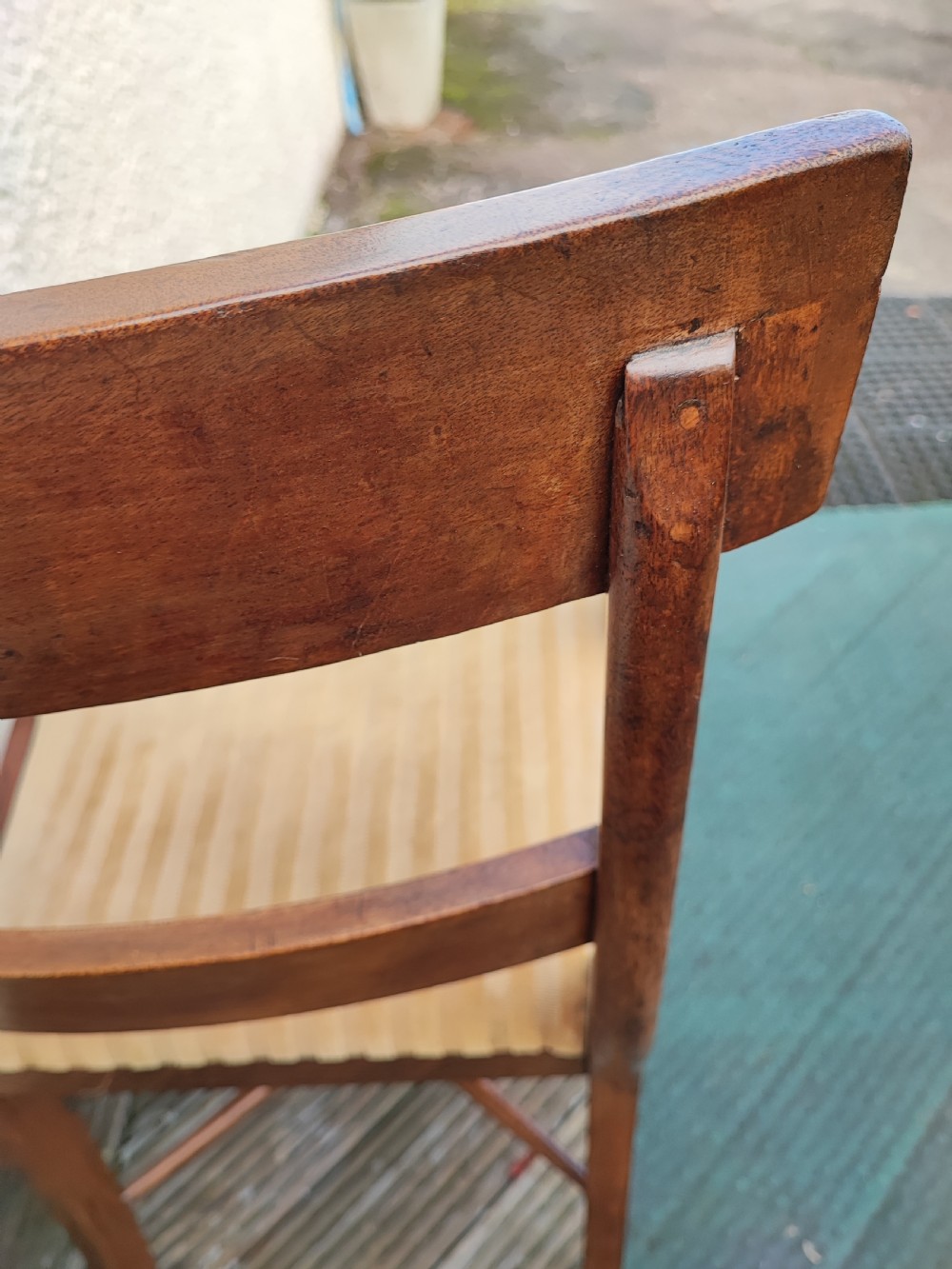 A Regency mahogany armchair featuring curved scroll arms, sabre legs, cross stretchers, and a yellow striped fabric seat. View VIII