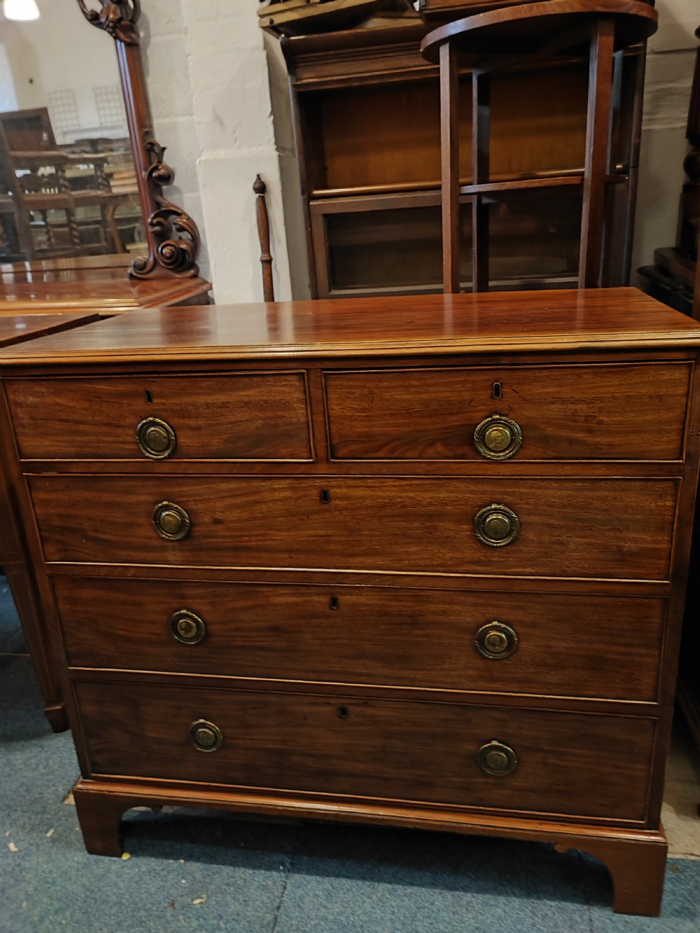 A rare Georgian mahogany chest of drawers,with original handles depicts the profile of King George III. View V
