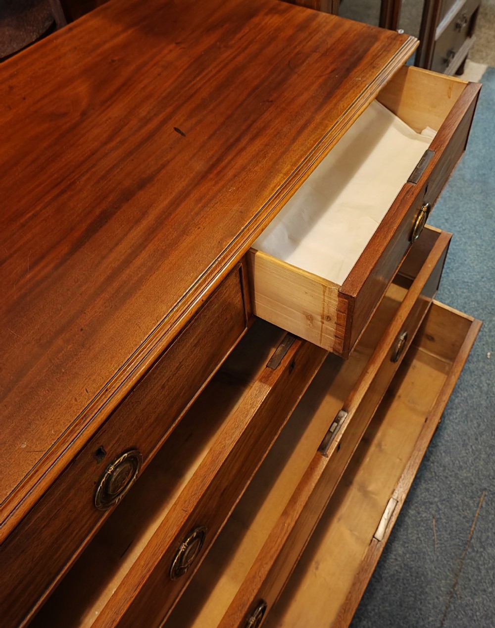 A rare Georgian mahogany chest of drawers,with original handles depicts the profile of King George III. View VI